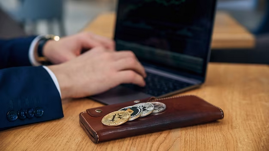 Man with laptop and cryptocurrency coins